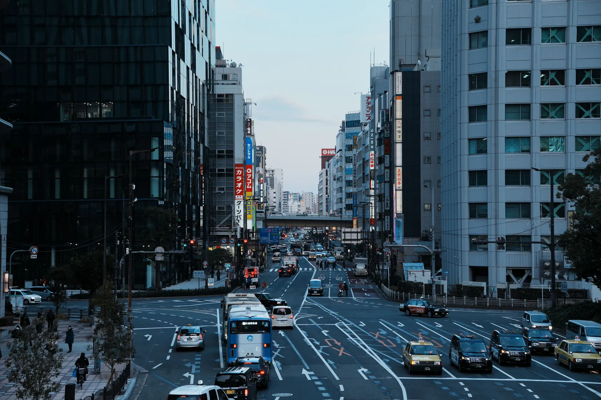 Traffic and tall buildings on a wide street in Tokyo